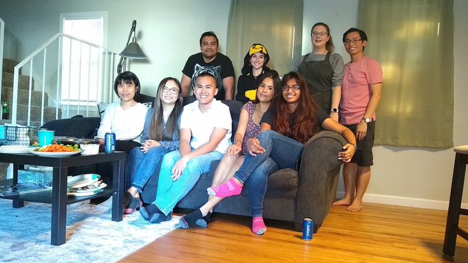 Image of Kristufek Lab member in a room with four people in the back row and five people sitting on a couch on the front row